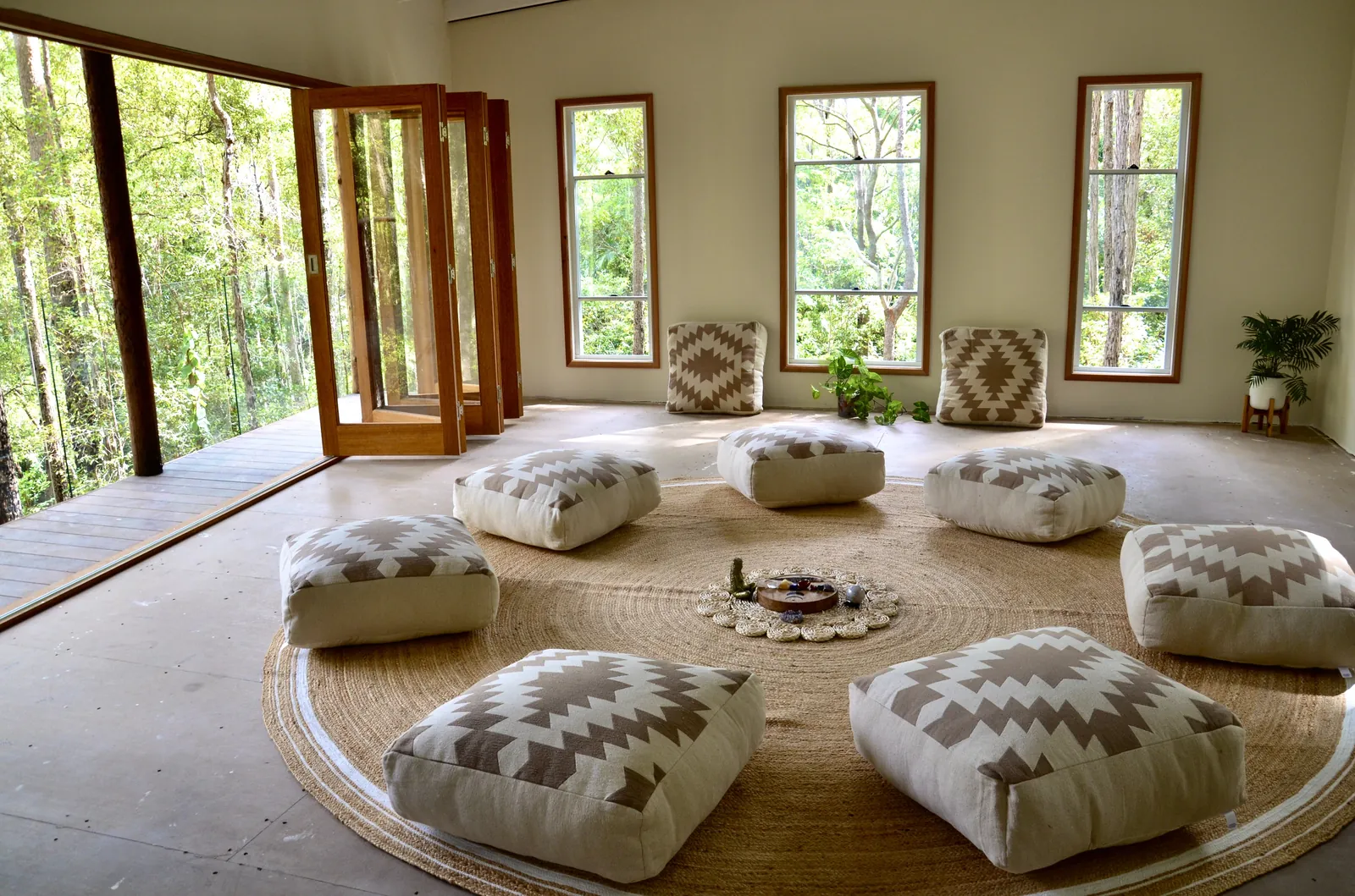 The round temple room at Ilkley Haven with cushions arranged in a circle around a flower mandala